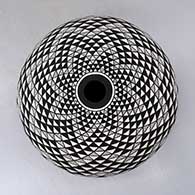 A black on white seed pot decorated with a spiral mesa and geometric design
 by Robert Kasero Sr of Laguna
