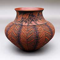 A polychrome tiny coil jar decorated with a sgraffito and painted vine, leaf and geometric design
 by Richard Zane Smith of Wyandot