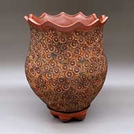 A polychrome jar polished on the inside and decorated on the outside with a stamped-and-painted geometric design below a polished brown crown around the opening, with a matching custom stand
 by Jamie Zane Smith of Wyandot