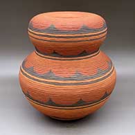 A polychrome double-lobed jar with exposed coils, an infinity rim and decorated with a geometric design
 by Jamie Zane Smith of Wyandot