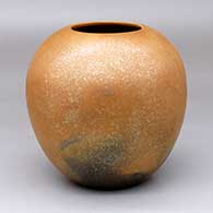 A golden micaceous jar with fire clouds
 by Robert Vigil of Nambe