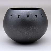 A micaceous black bowl decorated with a band of indented triangles below the rim
 by Robert Vigil of Nambe