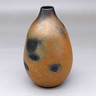 A golden micaceous vase with fire clouds
 by Robert Vigil of Nambe
