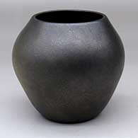 An oval plain black micaceous jar with fire clouds
 by Robert Vigil of Nambe