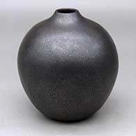 A black micaceous jar with a small, raised opening
 by Robert Vigil of Nambe