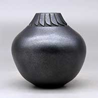 A black micaceous jar decorated with a lightly carved band of feathers around the neck, click or tap to see a larger version