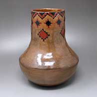 A polychrome jar with a band of Navajo carpet design around the neck
 by Stuart Riley Jr of Dineh
