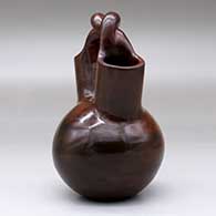 A brown wedding vase with fire clouds and a twisted bridge, click or tap to see a larger version