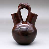 A brown wedding vase with fire clouds and a twisted bridge, click or tap to see a larger version