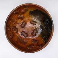 An open brown bowl with fire clouds and corn plant, cactus and horned toad appliques
 by Larrisena Manygoats of Dineh