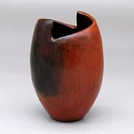 A brown jar with a geometric cut opening and fire clouds
 by Alice Cling of Dineh