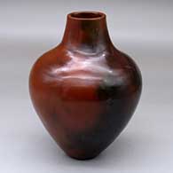 A brown jar with fire clouds
 by Alice Cling of Dineh