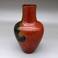 A large polished brown vase decorated with fire clouds
 by Alice Cling of Dineh