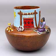 A polychrome Navajo Lifestyle pot with a sitting woman reading, with dog and sheep appliques
 by Elizabeth Manygoats of Dineh