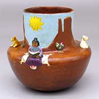 A polychrome Navajo Lifestyle pot with a sitting woman reading, a dog and two sheep appliques
 by Elizabeth Manygoats of Dineh