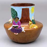 A polychrome Navajo Lifestyle pot with a woman reading, a dog and two sheep appliques
 by Elizabeth Manygoats of Dineh