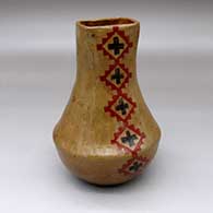 A low-shouldered polychrome jar with a square opening and decorated on two sides with a Navajo carpet pattern design
 by Lorraine Williams of Dineh