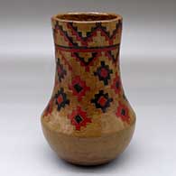 A low-shouldered polychrome jar decorated above the shoulder with a Navajo carpet design pattern
 by Lorraine Williams of Dineh