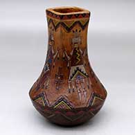 A polychrome jar with a square neck and decorated with a sgraffito and painted yeibichai and geometric design
 by Nancy Yazzie of Dineh