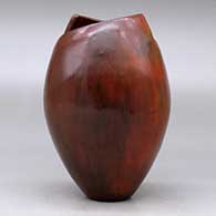 A polished brown jar with a geometric cut opening and decorated with fire clouds, click or tap to see a larger version