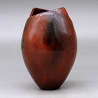 A polished brown jar with a geometric cut opening and decorated with fire clouds, click or tap to see a larger version