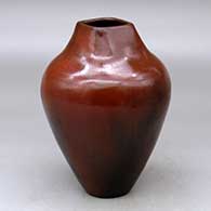 A polished brown with a square opening and decorated with fire clouds
 by Alice Cling of Dineh