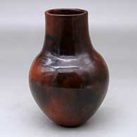 A polished brown vase decorated with fire clouds
 by Alice Cling of Dineh