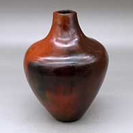 A polished brown with a short neck and square opening, decorated with fire clouds
 by Alice Cling of Dineh