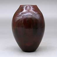 A polished brown vase with a square opening and decorated with fire clouds, click or tap to see a larger version