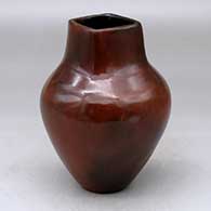 A polished brown vase decorated with fire clouds and a short, square neck
 by Alice Cling of Dineh