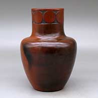 A polished brown jar with fire clouds decorated around the neck with a sgraffito geometric design, click or tap to see a larger version