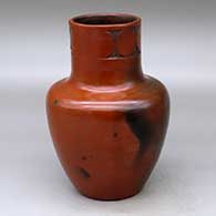 A polished brown jar with fire clouds decorated around the neck with a sgraffito geometric design
 by Sue Williams of Dineh