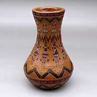A low shouldered polychrome jar decorated with a sgraffito and painted Yeibichai, cloud pattern and geometric design
 by Nancy Yazzie of Dineh
