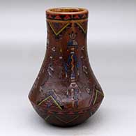 A polychrome vase with a tall neck and decorated with a sgraffito and painted yeibichai and geometric design
 by Nancy Yazzie of Dineh