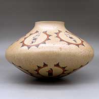 A large polychrome jar decorated with medallions of dancer and geometric design, click or tap to see a larger version