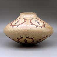 A large polychrome jar decorated with medallions of dancer and geometric design, click or tap to see a larger version