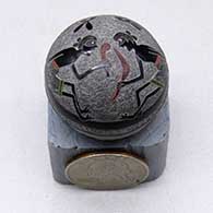 A polychrome seed pot decorated with a Pueblo dancer, animal and geometric design
 by Joseph Lonewolf of Santa Clara