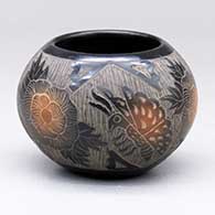 A black jar with dark sienna spots and a three-panel sgraffito butterfly, flower and geometric design
 by Melvin Moquino of Santa Clara