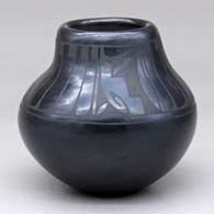 A black on black jar decorated with a band of feather and geometric design above the shoulder
 by Linda Askan of Santa Clara