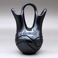 A black wedding vase with an avanyu design carved around the shoulder, click or tap to see a larger version