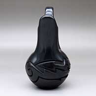 A black wedding vase with an avanyu design carved around the shoulder, click or tap to see a larger version