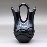 A black wedding vase with an avanyu design carved around the shoulder, click or tap to see a larger version