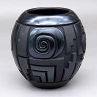 A black jar with a four-panel carved spiral, kiva step and geometric design in polished black and matte black
 by Harrison Begay Jr of Santa Clara