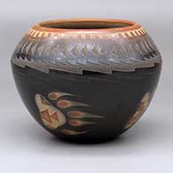 A black bowl wit a sienna rim and spots plus a sgraffito feather, bear paw and geometric design
 by Justin Naranjo of Santa Clara