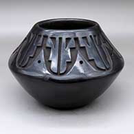 A black jar carved above the shoulder with an eight-panel geometric design
 by Chris Martinez of Santa Clara