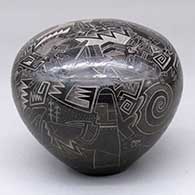 A black seed pot with sienna spots and decorated with a sgrafito pueblo, dancer, bird element, rock art, feather and geometric design
 by Dean Haungooah of Santa Clara