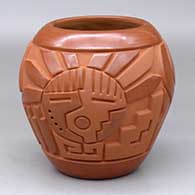 A matte-and-polished red jar carved with a yei, spiral and geometric design
 by Harrison Begay Jr of Santa Clara