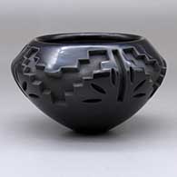 A black bowl carved with a four-panel kiva step and geometric design
 by Effie Garcia of Santa Clara