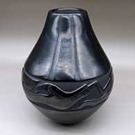 A large black jar carved with an avanyu design around the shoulder
 by LuAnn Tafoya of Santa Clara