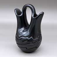 A black wedding vase with an avanyu design carved around the shoulder
 by Vickie Martinez of Santa Clara